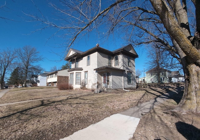 view of side of property with a lawn