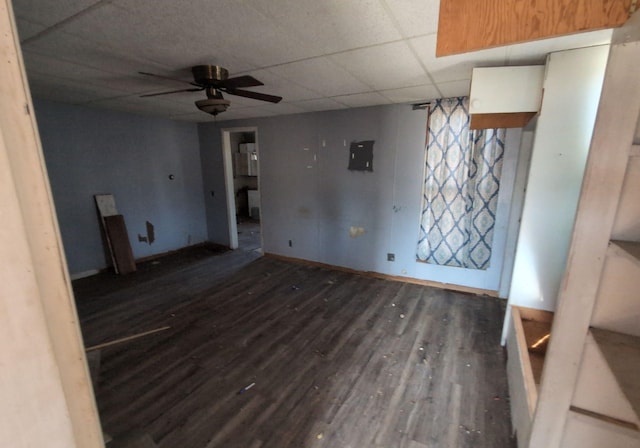 unfurnished living room with a paneled ceiling, dark hardwood / wood-style floors, and ceiling fan