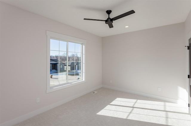 unfurnished room with carpet floors and ceiling fan