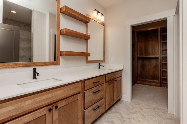 bathroom featuring an enclosed shower and vanity