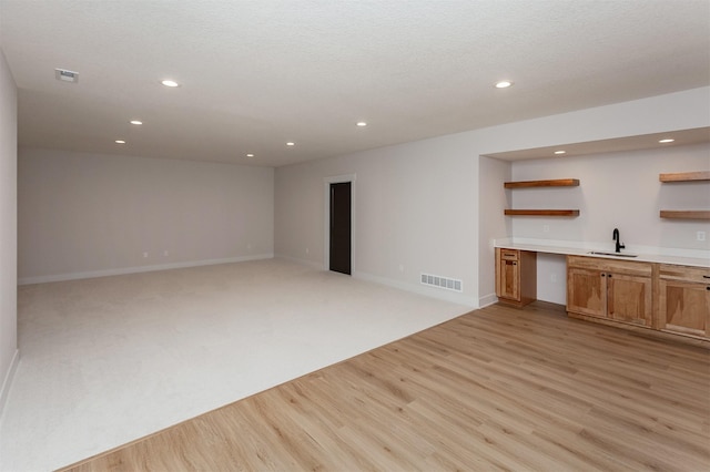 interior space featuring sink and light hardwood / wood-style floors