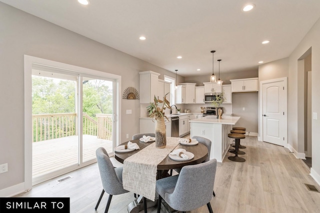 dining area with sink and light hardwood / wood-style flooring