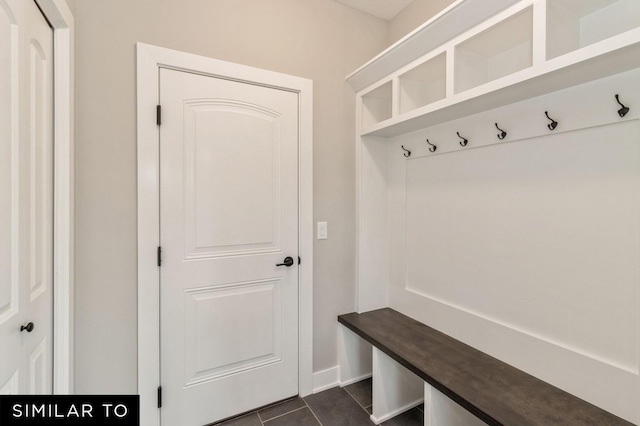 mudroom featuring dark tile patterned floors