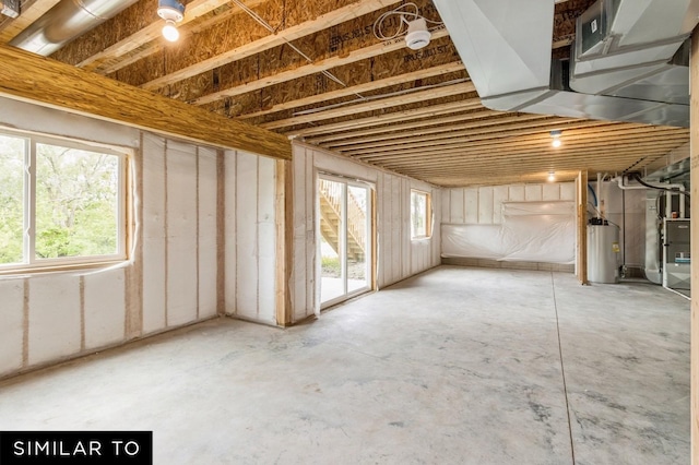 basement with water heater and heating unit