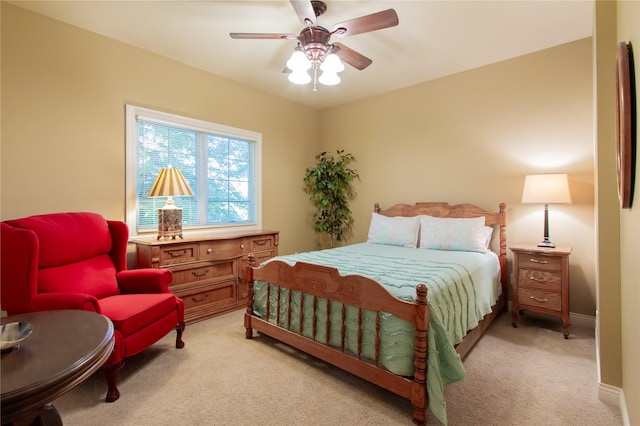 bedroom with ceiling fan and light colored carpet