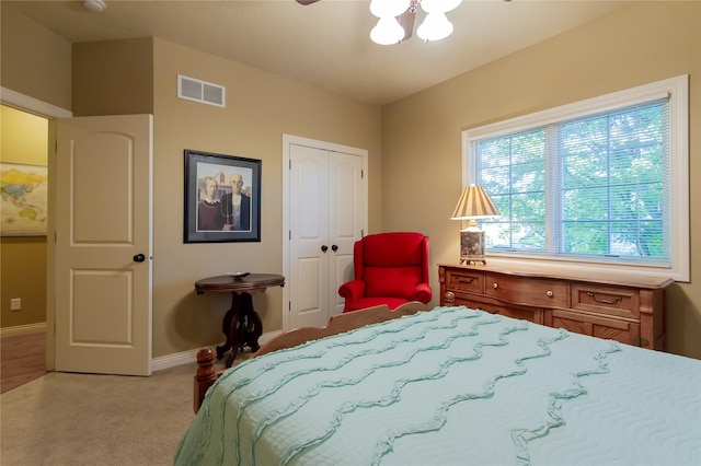 carpeted bedroom with a closet and ceiling fan