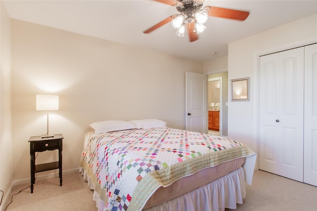 carpeted bedroom with ceiling fan and a closet