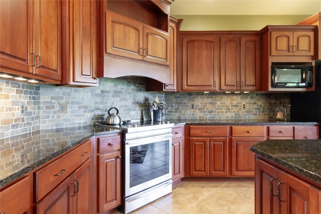 kitchen featuring light tile patterned flooring, decorative backsplash, dark stone counters, and stainless steel electric range