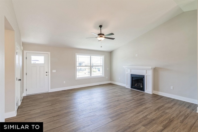 unfurnished living room with vaulted ceiling, dark wood-type flooring, a wealth of natural light, and ceiling fan