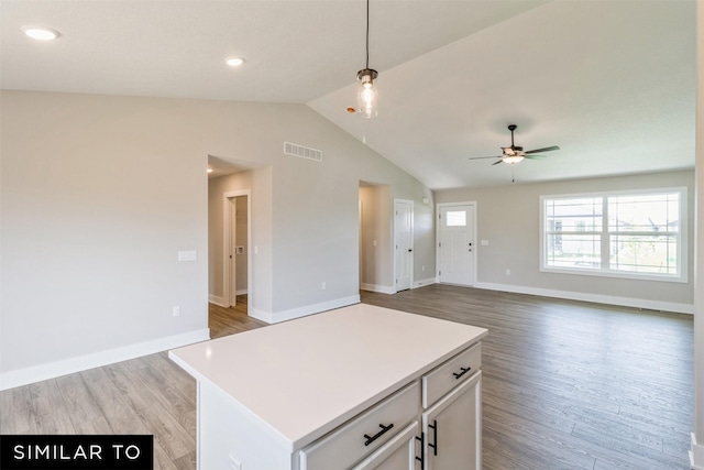 kitchen with white cabinetry, ceiling fan, light wood-type flooring, a kitchen island, and pendant lighting