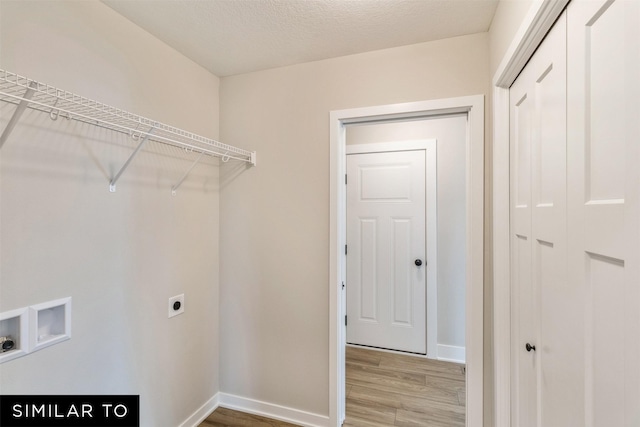 clothes washing area featuring hookup for an electric dryer, hookup for a washing machine, and hardwood / wood-style floors