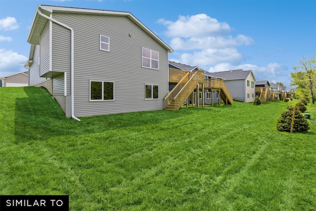 rear view of property with a deck and a lawn