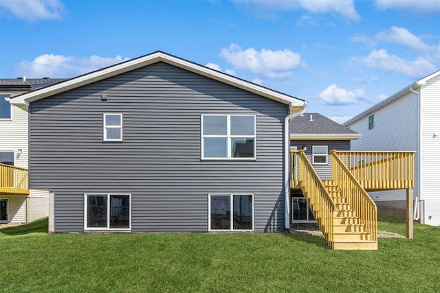 4207 NE 3rd St, Ankeny, IA 50021 - back of property with a lawn, stairway, and a deck