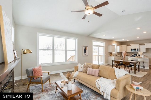 living room featuring ceiling fan, vaulted ceiling, and dark hardwood / wood-style flooring