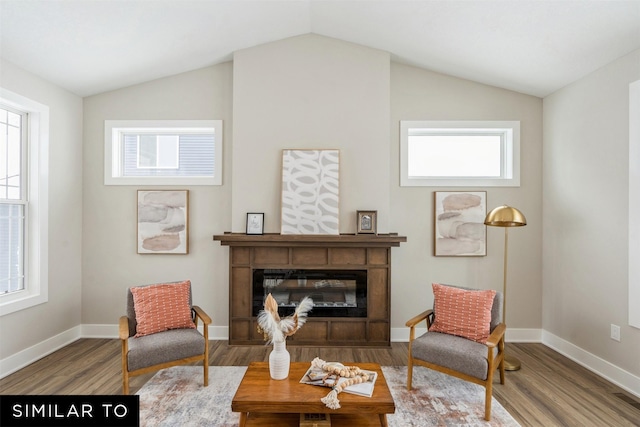 living area with lofted ceiling and hardwood / wood-style floors