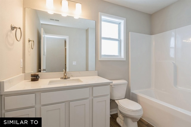 full bathroom featuring toilet, vanity, and bathing tub / shower combination