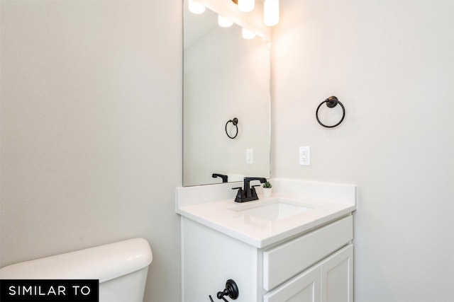 bathroom with toilet and vanity