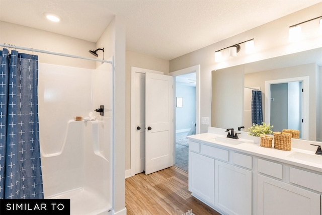 bathroom with vanity, a shower with curtain, and hardwood / wood-style floors