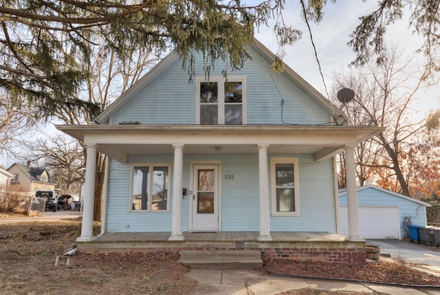 bungalow-style home featuring an outbuilding, covered porch, and a garage