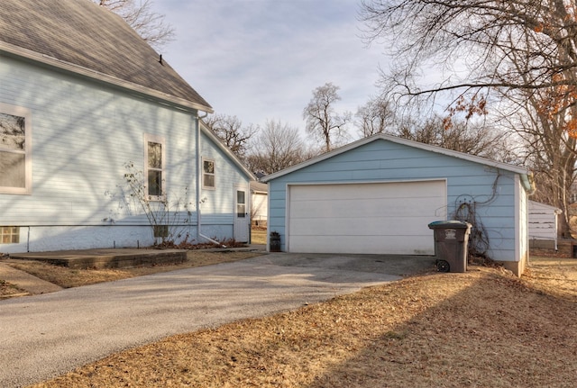 view of side of property featuring an outbuilding and a garage