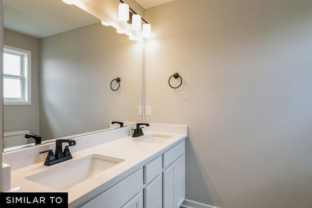 bathroom featuring toilet and vanity