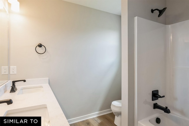 full bathroom featuring toilet, wood-type flooring, vanity, and shower / bathing tub combination