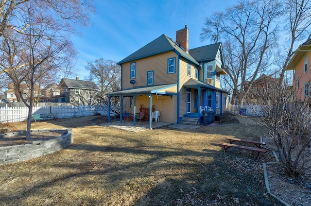 rear view of property with a lawn