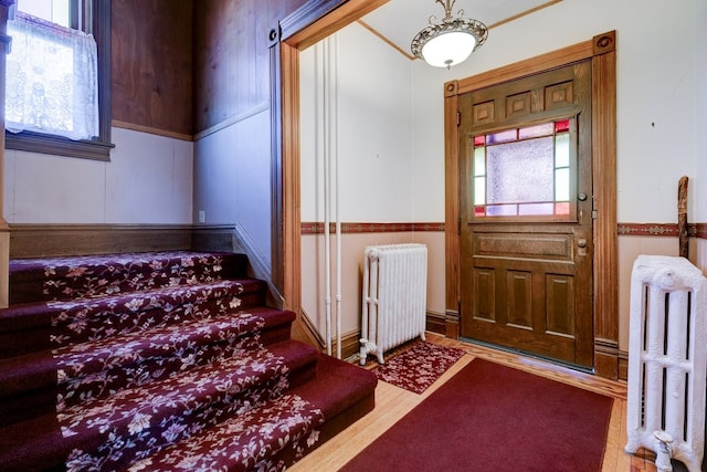 foyer featuring hardwood / wood-style flooring and radiator heating unit