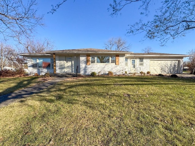 view of front of home with a front yard and a garage