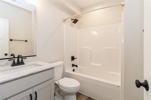 full bathroom with toilet,  shower combination, hardwood / wood-style floors, and vanity