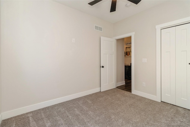 unfurnished bedroom featuring ceiling fan, a closet, and carpet floors