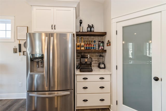 interior space with white cabinets, backsplash, stainless steel fridge, and dark hardwood / wood-style floors