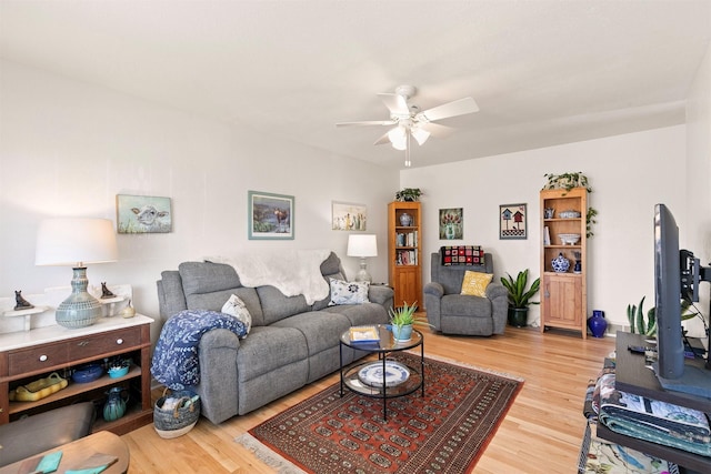 living room with ceiling fan and hardwood / wood-style floors