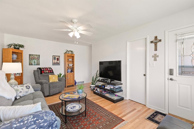 living room with ceiling fan and wood-type flooring