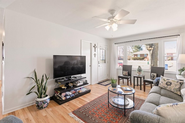 living room with ceiling fan and hardwood / wood-style floors