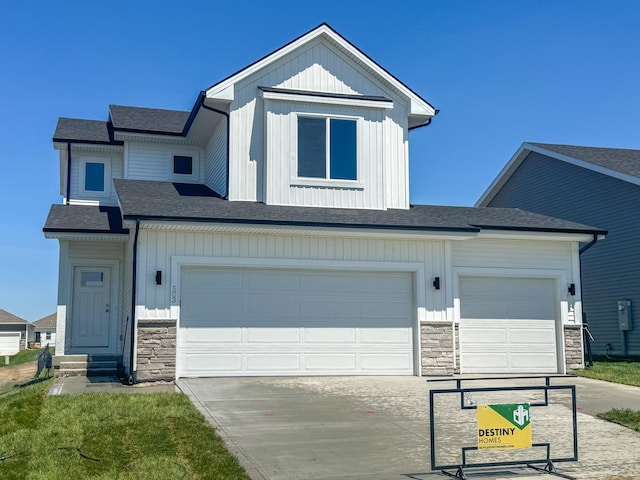503 43rd St SW, Altoona, IA 50009 - modern farmhouse style home with stone siding, concrete driveway, board and batten siding, and entry steps