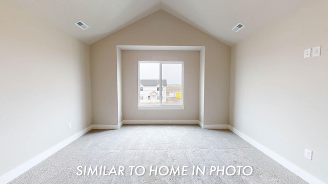 503 43rd St SW, Altoona, IA 50009 - unfurnished room with light colored carpet, visible vents, and lofted ceiling