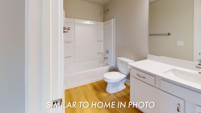 503 43rd St SW, Altoona, IA 50009 - bathroom featuring vanity, toilet, wood finished floors, and shower / tub combination