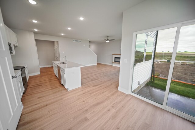 503 43rd St SW, Altoona, IA 50009 - kitchen with a sink, appliances with stainless steel finishes, a ceiling fan, recessed lighting, and white cabinets