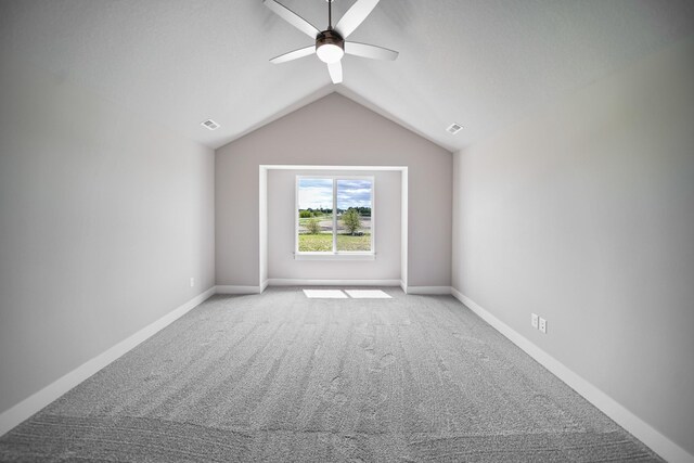 503 43rd St SW, Altoona, IA 50009 - unfurnished room with light colored carpet, a ceiling fan, vaulted ceiling, and baseboards