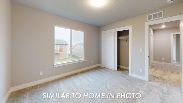 7046 SE 7th Ave, Pleasant Hill, IA 50327 - unfurnished bedroom with carpet flooring, a closet, visible vents, and baseboards
