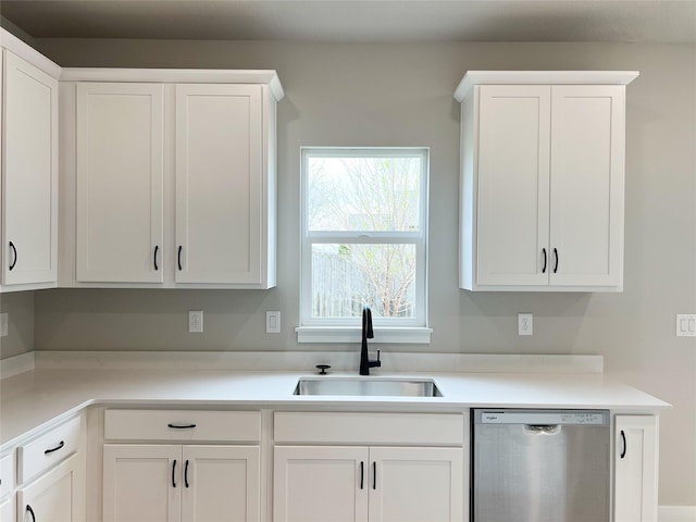 7046 SE 7th Ave, Pleasant Hill, IA 50327 - kitchen with stainless steel dishwasher, a sink, white cabinetry, and light countertops
