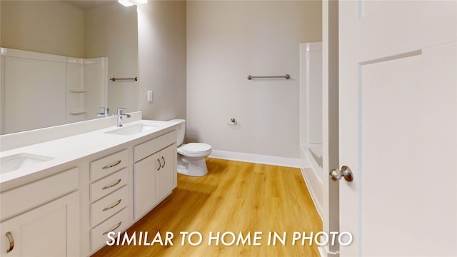 bathroom featuring vanity, hardwood / wood-style floors, and toilet