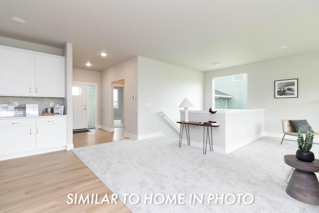 kitchen with recessed lighting, light wood-style flooring, baseboards, and white cabinetry