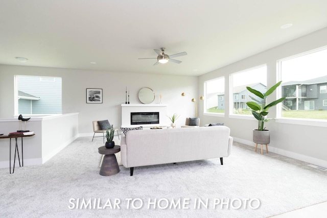living room featuring visible vents, baseboards, carpet flooring, and ceiling fan