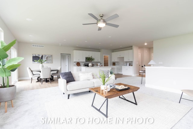 living room featuring ceiling fan, baseboards, visible vents, and recessed lighting