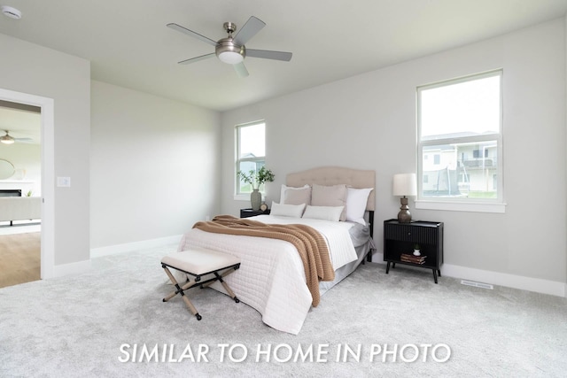 bedroom with baseboards, a ceiling fan, and carpet flooring