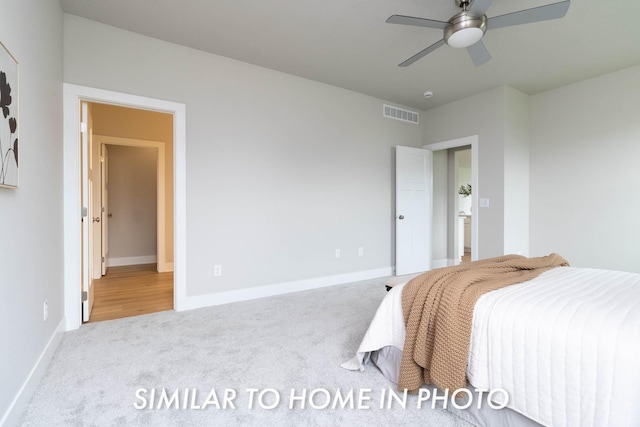 bedroom with baseboards, a ceiling fan, visible vents, and carpet