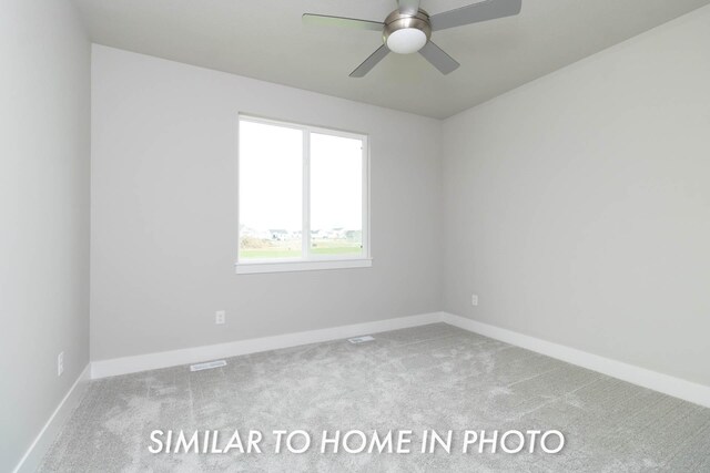 unfurnished room with ceiling fan, baseboards, and carpet