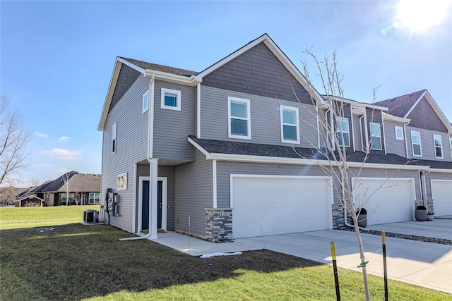 multi unit property with central air condition unit, a front lawn, and a garage